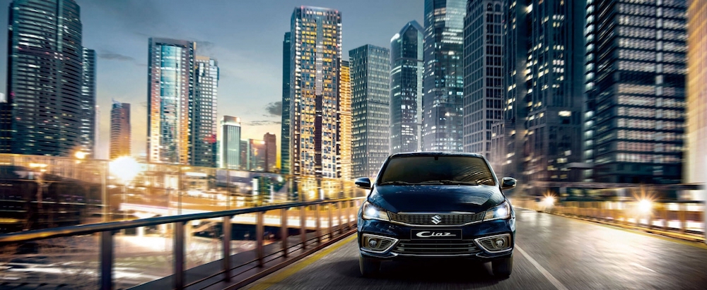 Suzuki Ciaz Front Grille View Driving in City on Highway with City Background